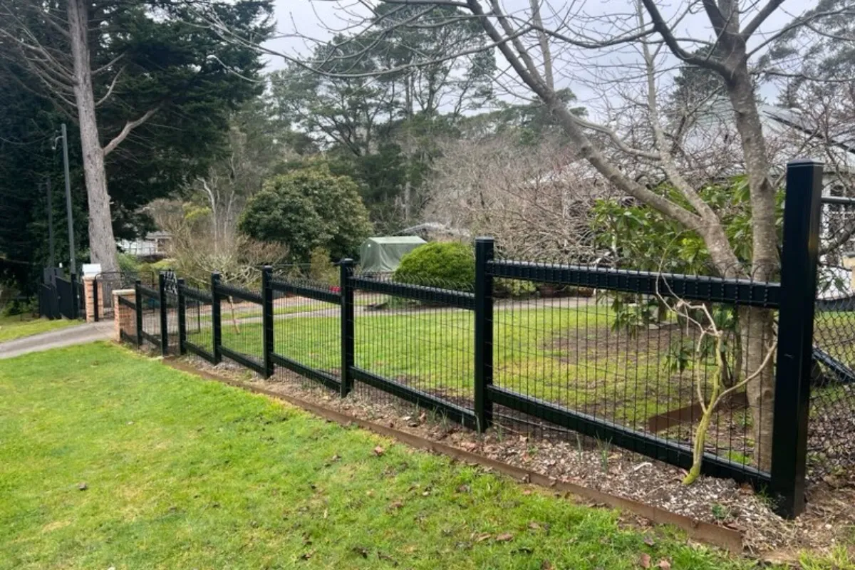 Stepped black emu wire boundary fence on slope